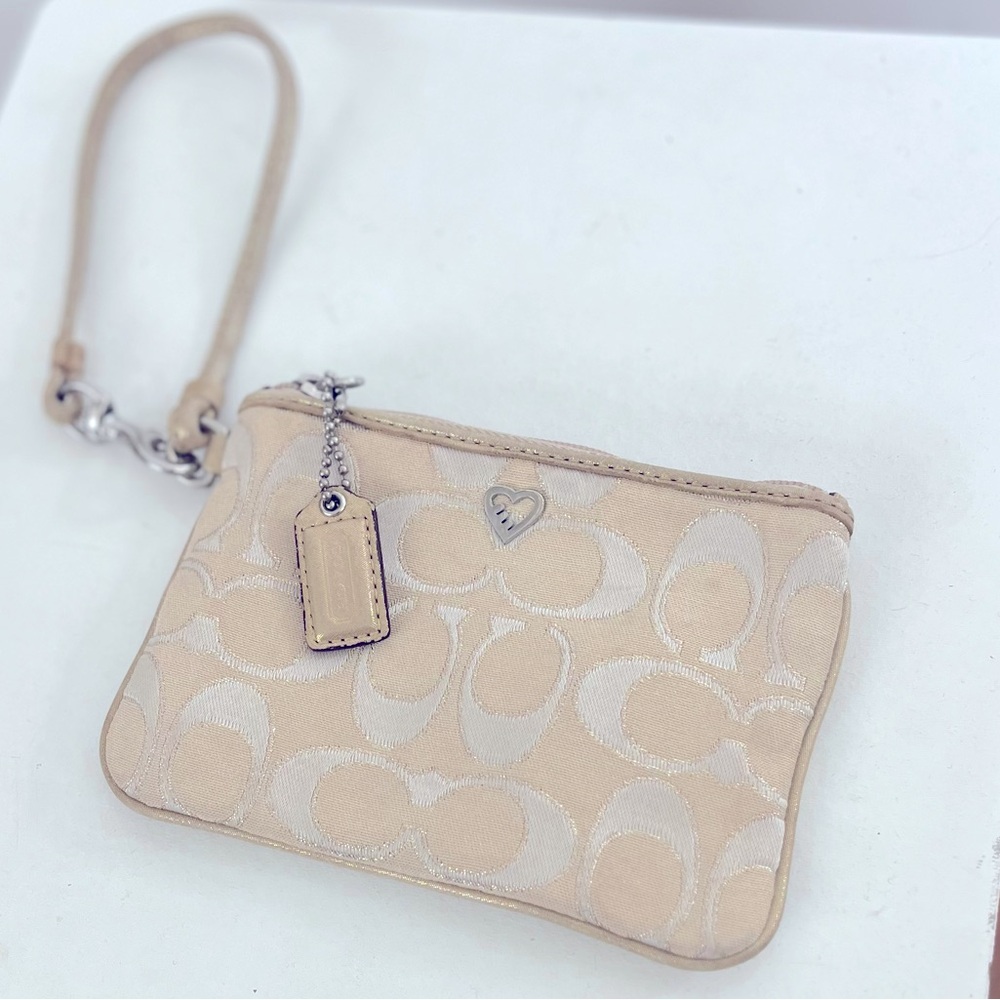 Coach Poppy Wristlet. Cream and Gold Canvas Logo Print with Pink Satin interior.